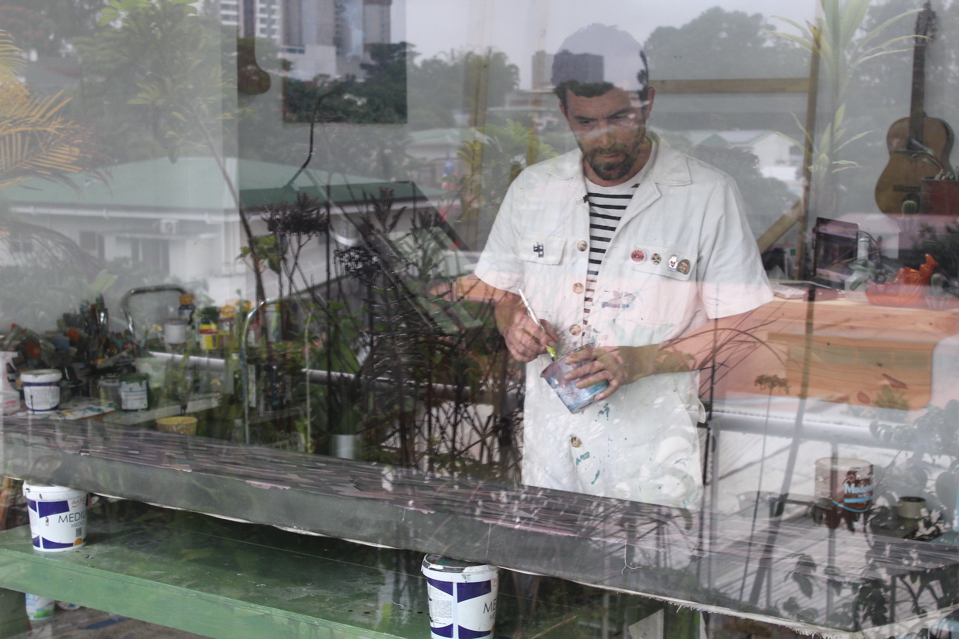 Fabian Monge painting in his workshop