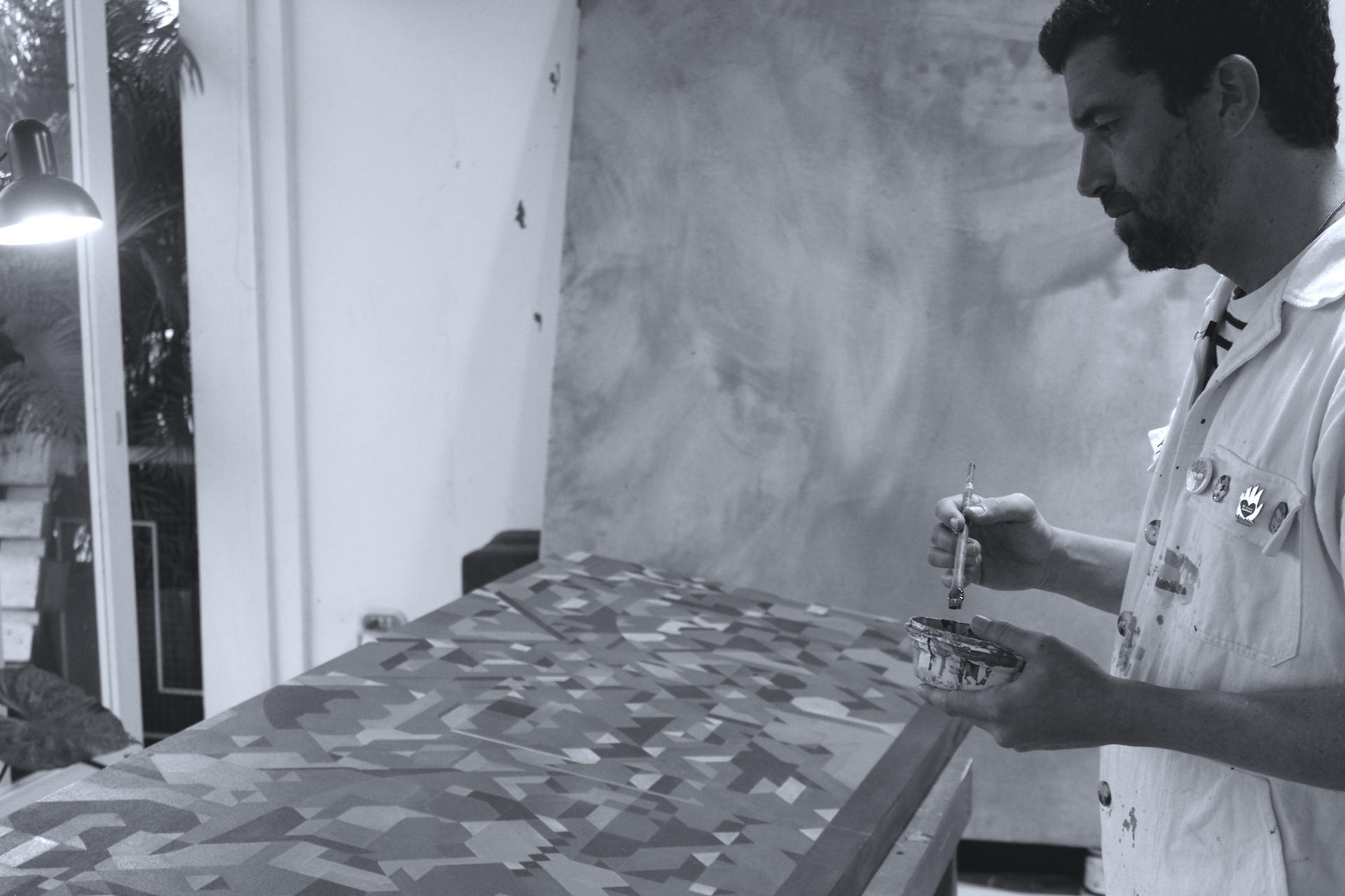 Fabian Monge painting in his workshop