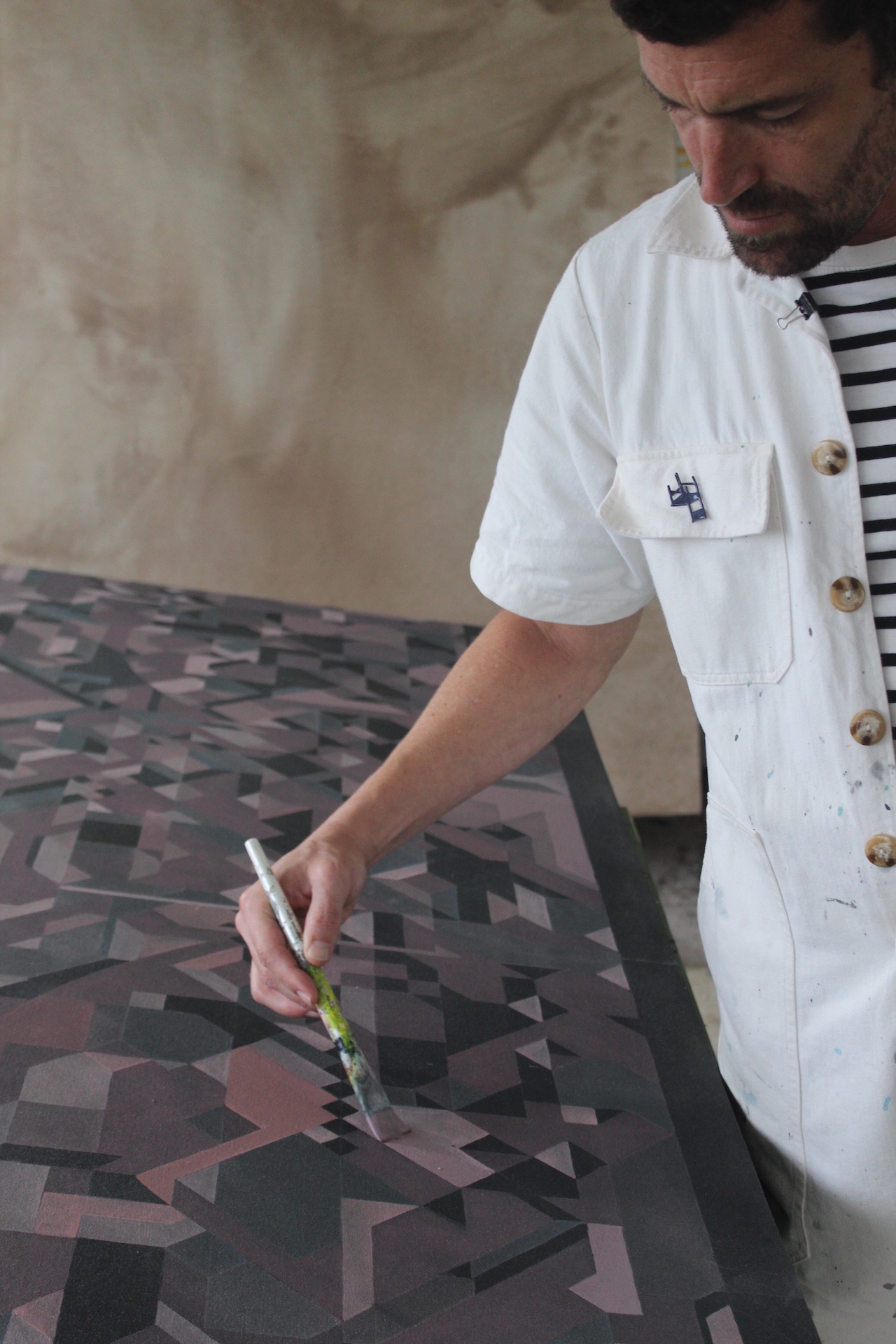 Fabian Monge painting in his workshop