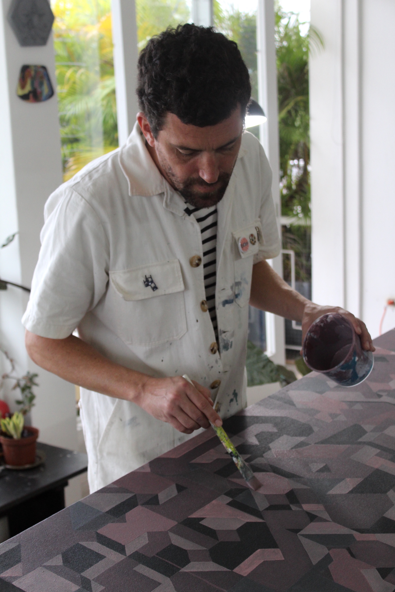 Fabian Monge painting in his workshop
