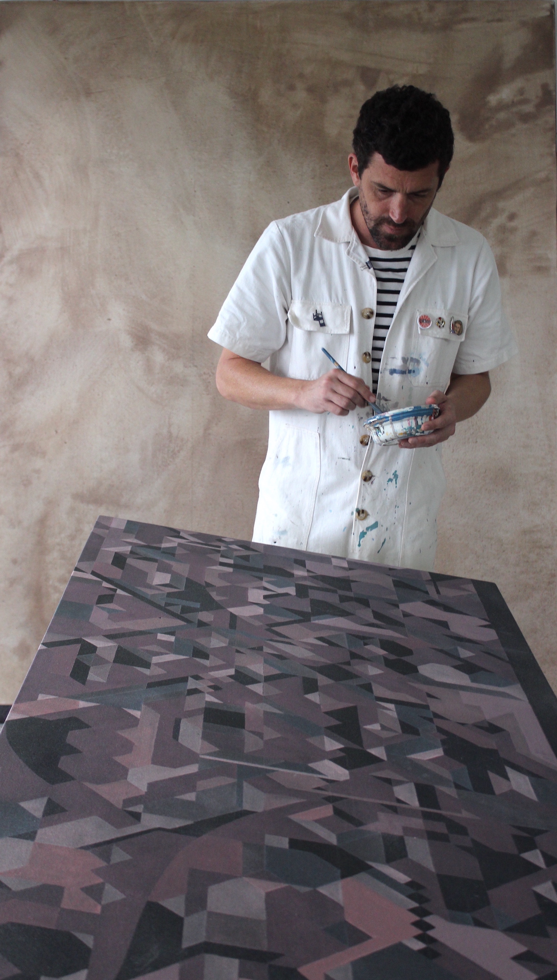 Fabian Monge painting in his workshop